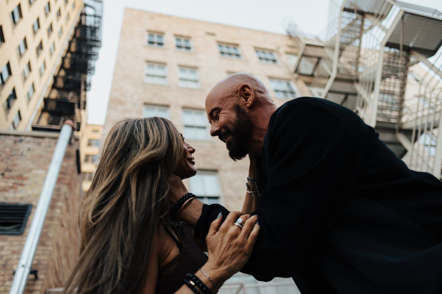 Shawn Feurer laughing with his wife in the city