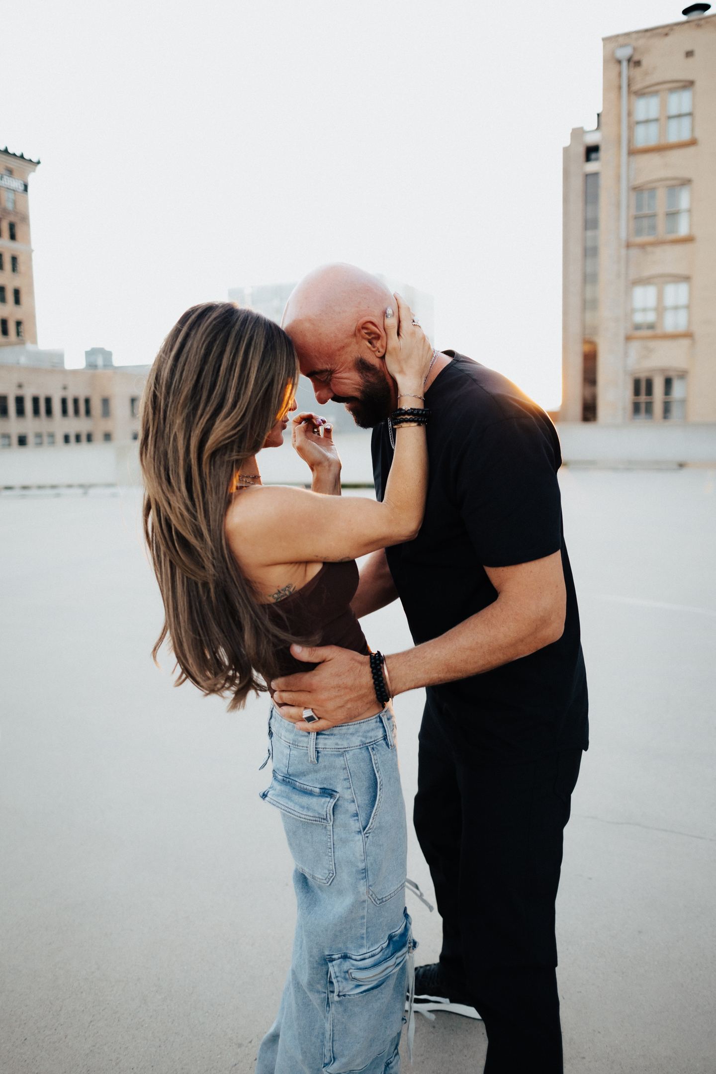 Shawn Feurer and his wife sharing a moment on a city rooftop